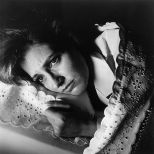 B/W portrait of a stressed woman lying in bed